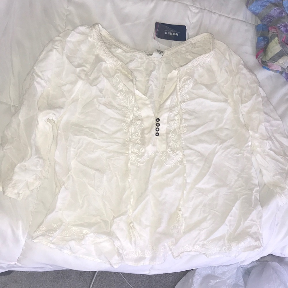 A white flowery top that has never been worn